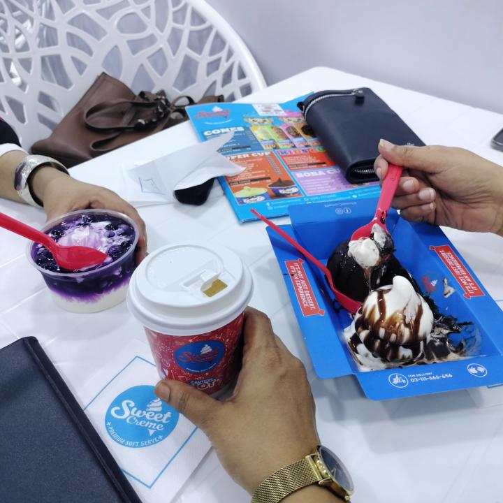 Friends gathering on sweet cream restaurant. 