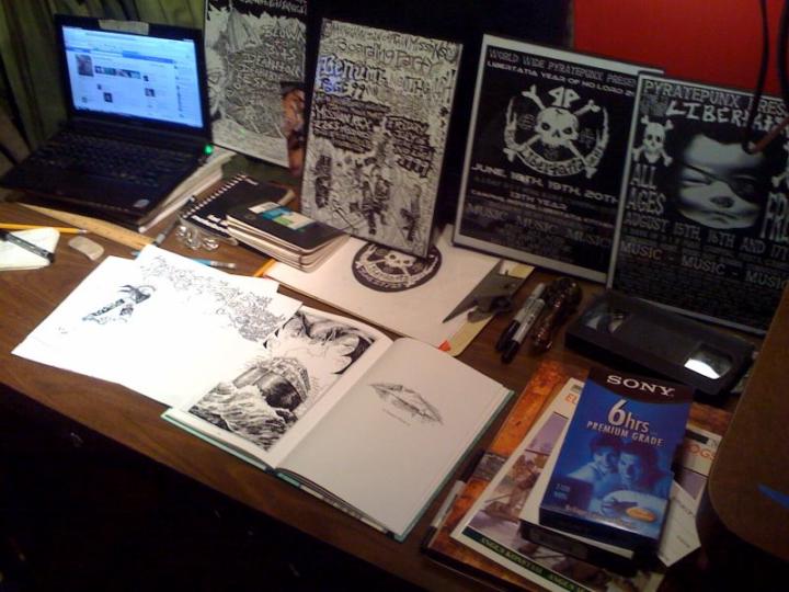 My art studio with a pile of my artwork.