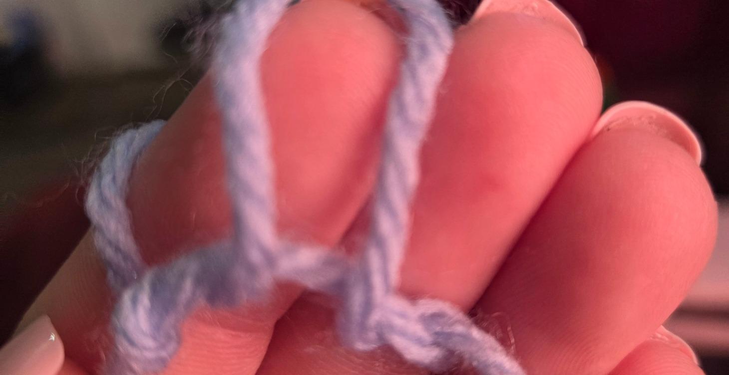 Learning how to make a slip knot.
