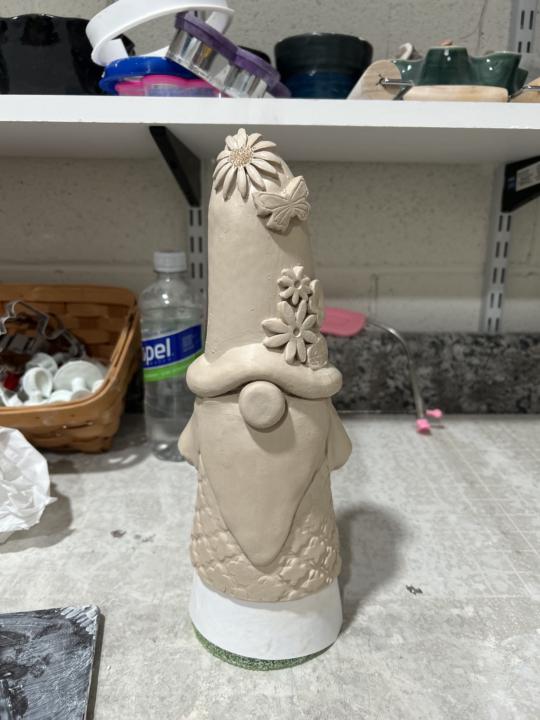 How do I get him off cone?  I’m new at hand building and wrapped my cone with paper but he’s still stuck.