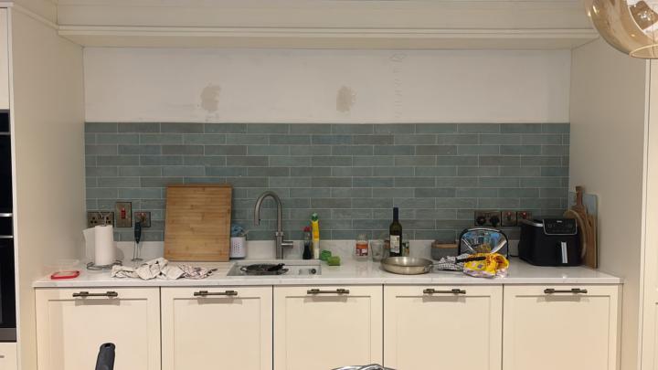 Wall above tiles
